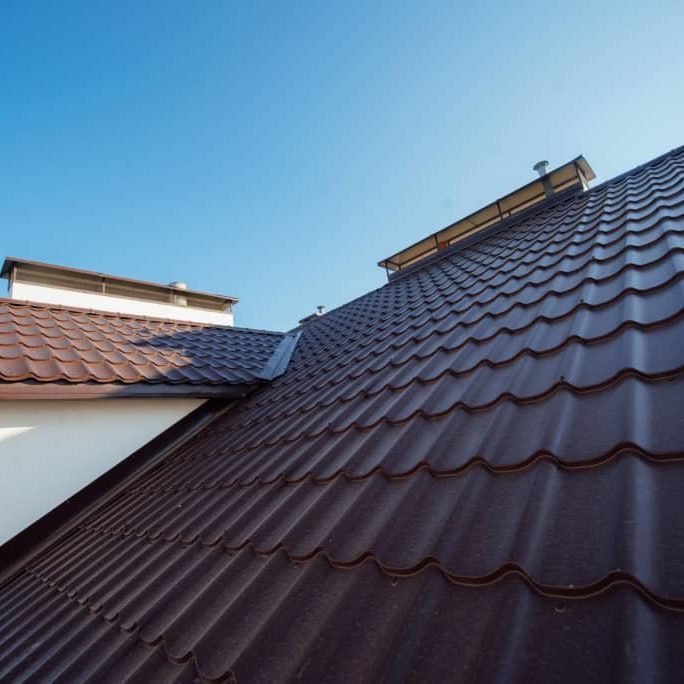 Tile Roof of a two-story white cottage